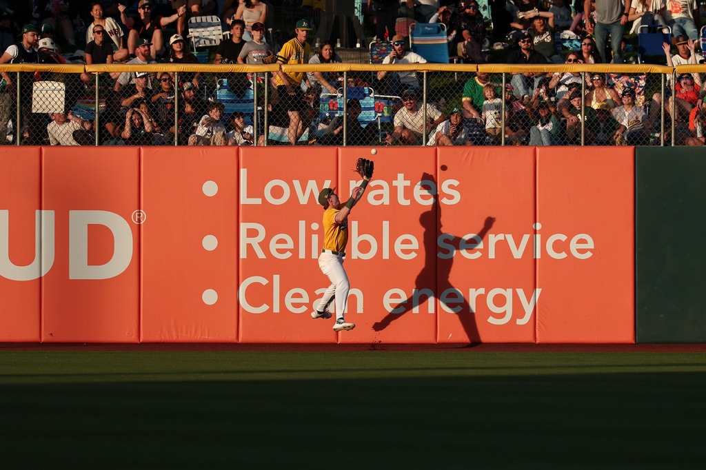 Athletics center fielder Henry Bolte attempts to catch a fly ball hit by San Francisco Giants' Drew Gilbert during the fourth inning of a baseball game Saturday, May 16, 2026, in West Sacramento, Calif. (AP Photo/Sara Nevis)