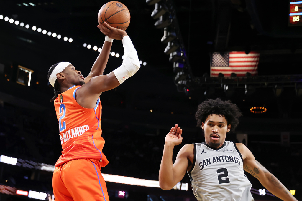 Oklahoma City Thunder guard Shai Gilgeous-Alexander (2) goes for a shot over San Antonio Spurs guard Dylan Harper (2) in the first half of an NBA Cup semifinals basketball game, Saturday, Dec. 13, 2025, in Las Vegas. (AP Photo/Ronda Churchill)