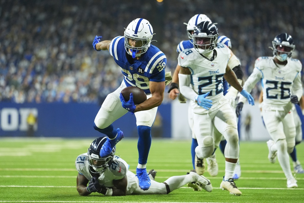 Indianapolis Colts running back Jonathan Taylor (28) goes in for a touchdown against Tennessee Titans cornerback Roger McCreary (21) during the second half an NFL football game, Sunday, Oct. 26, 2025, in Indianapolis. (AP Photo/Michael Conroy)