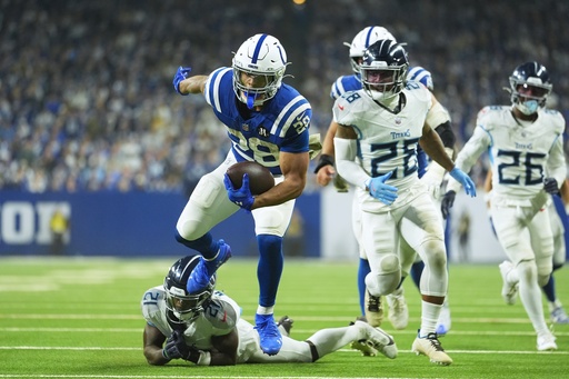 Indianapolis Colts running back Jonathan Taylor (28) goes in for a touchdown against Tennessee Titans cornerback Roger McCreary (21) during the second half an NFL football game, Sunday, Oct. 26, 2025, in Indianapolis. (AP Photo/Michael Conroy) Indianapolis Colts running back Jonathan Taylor (28) goes in for a touchdown against Tennessee Titans cornerback Roger McCreary (21) during the second half an NFL football game, Sunday, Oct. 26, 2025, in Indianapolis. (AP Photo/Michael Conroy)