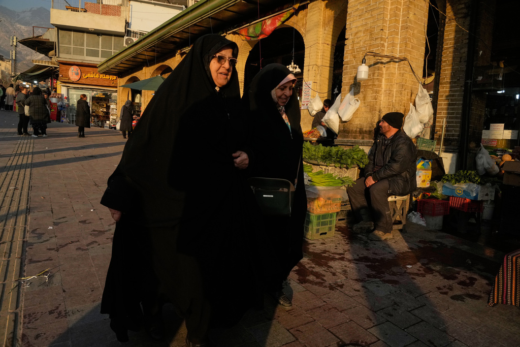 Women walk past the Tajrish bazaar in northern Tehran, Iran, Tuesday, Jan. 27, 2026. (AP Photo/Vahid Salemi)