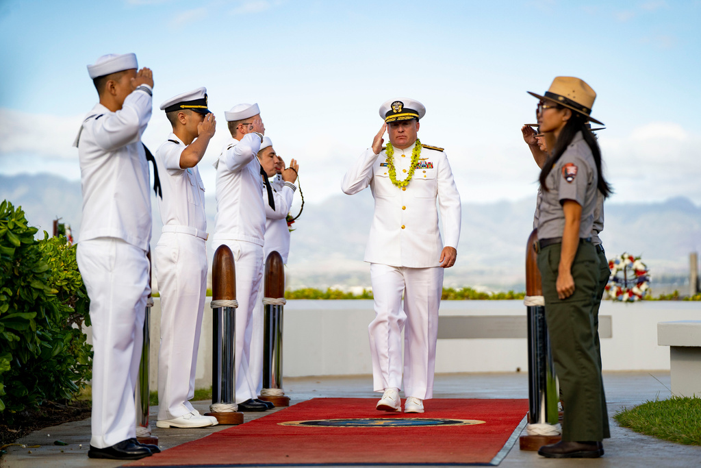Rear Adm. Brad Collins, commander of Navy Region Hawaii, salutes as he departs after the 84th Pearl Harbor Remembrance Day ceremony, Sunday, Dec. 7, 2025, in Honolulu. (AP Photo/Mengshin Lin)