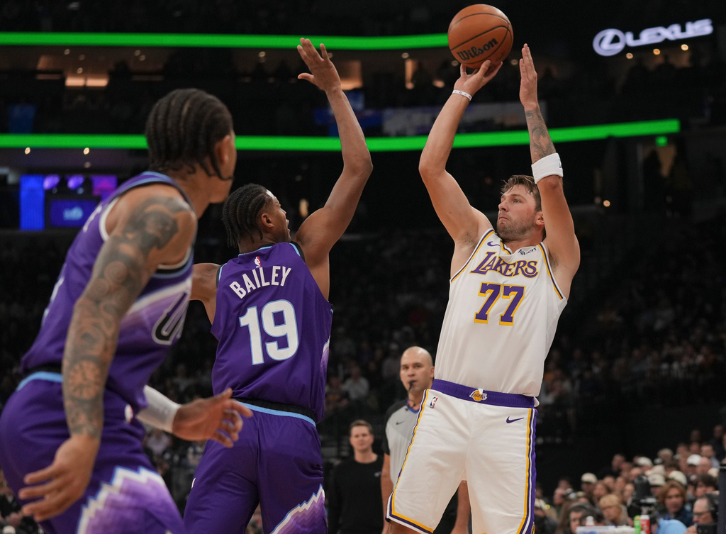 Los Angeles Lakers forward/guard Luka Dončić (77) looks to shoots as Utah Jazz forward Ace Bailey (19) defends during the first half of an NBA basketball game Sunday, Oct. 25, 2026, in Salt Lake City. (AP Photo/Bethany Baker)