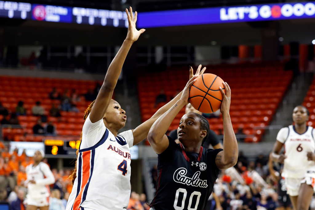 South Carolina guard Ta'niya Latson (00) looks to shoot as Auburn guard Kaitlyn Duhon (4) defends during the first period of an NCAA college basketball game Thursday, Jan. 29, 2026, in Auburn, Ala. (AP Photo/Butch Dill)