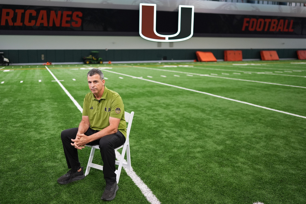 Miami football head coach Mario Cristobal sits on the team's indoor practice field during an interview in Coral Gables, Fla., Monday, Jan. 12, 2026. (AP Photo/Rebecca Blackwell)