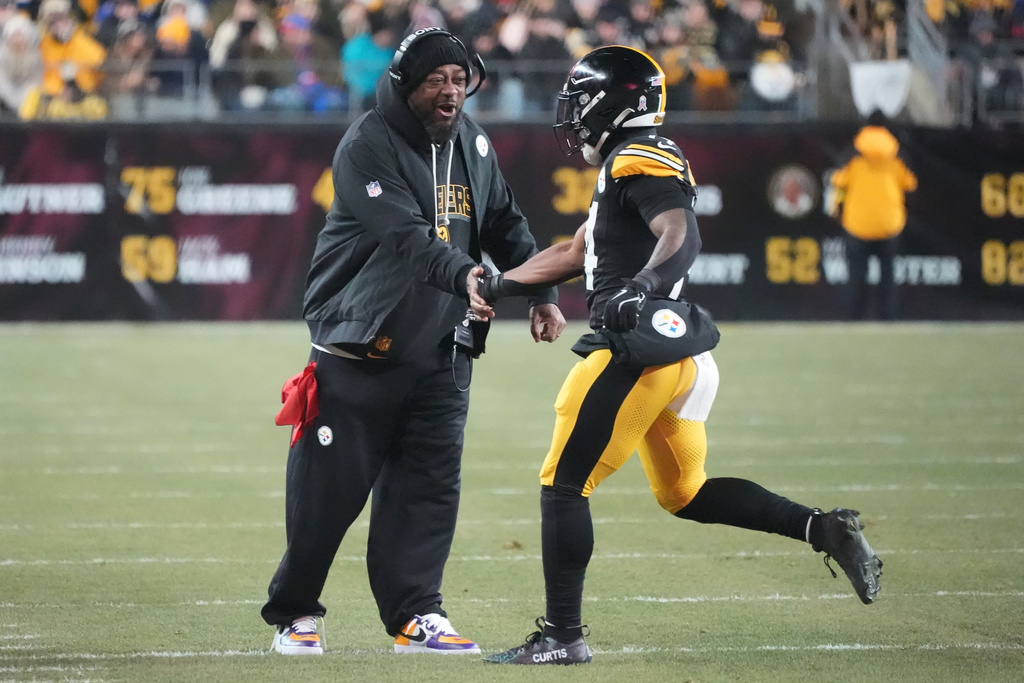 Pittsburgh Steelers head coach Mike Tomlin celebrates with running back Kenneth Gainwell, right, after a run during the first half of an NFL football game against the Buffalo Bills Sunday, Nov. 30, 2025, in Pittsburgh. (AP Photo/Gene J. Puskar)