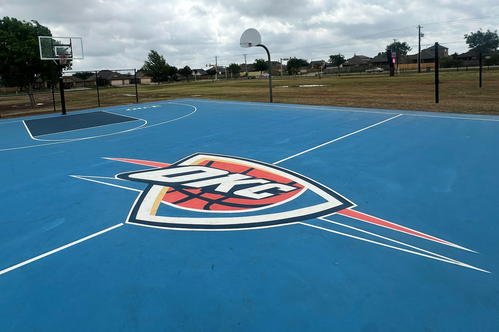 The outdoor basketball court at Briarwood Elementary School, destroyed in a tornado in 2013, is a sign of the connection between the the NBA basketball team Oklahoma City Thunder and the greater Oklahoma City community, in shown, April 15, 2026, in Oklahoma City. Thunder dedicated the court in 2014 and resurfaced it in 2024. (AP Photo/Cliff Brunt)