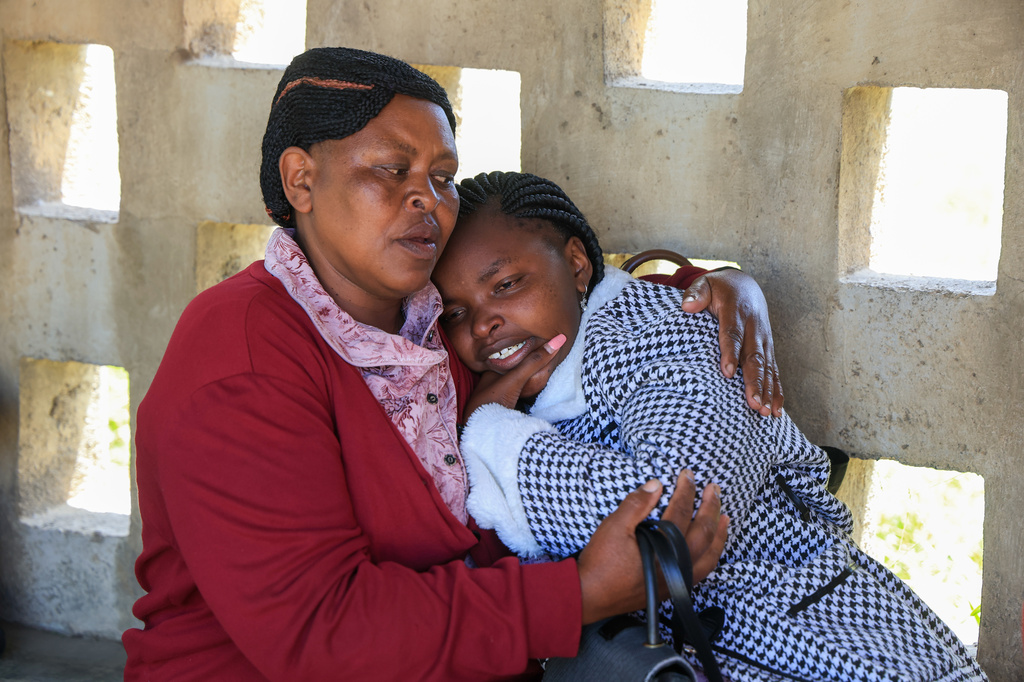 A parent of a victim of the fire at the Utumishi Girls Academy is consoled ahead of body identification and DNA testing at Naivasha Funeral Home in Naivasha Town, Rift Valley region, Kenya, Friday, May 29, 2026. (AP Photo/Andrew Kasuku)