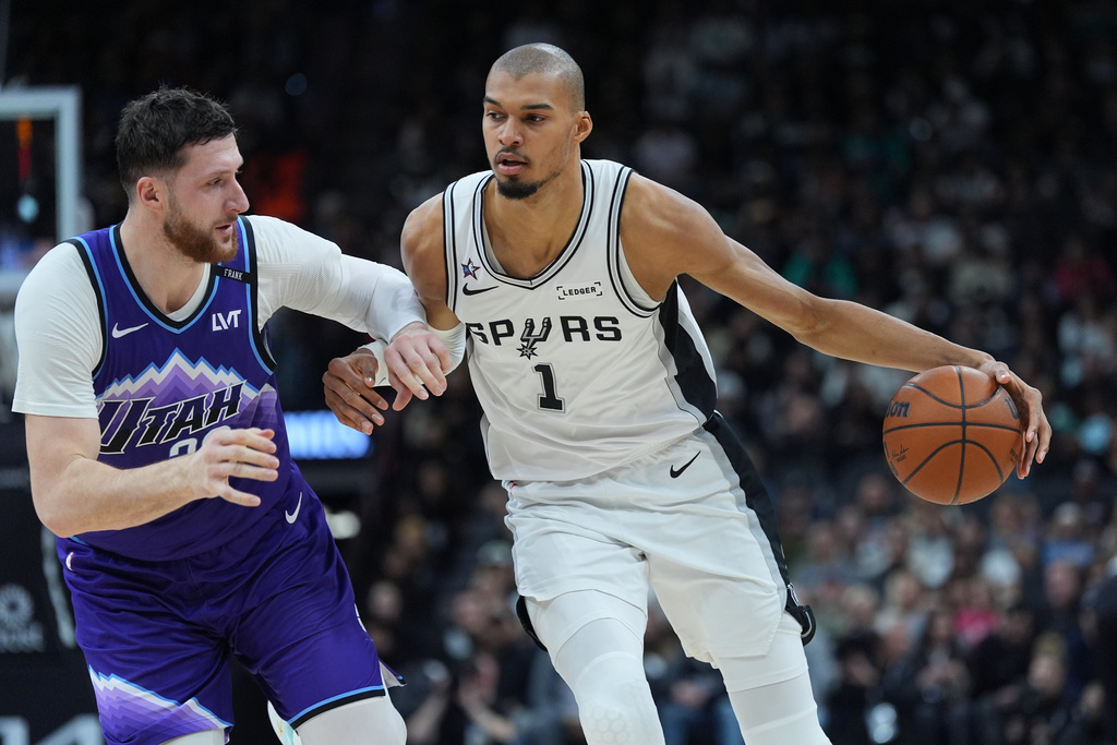 San Antonio Spurs forward Victor Wembanyama (1) drives around Utah Jazz center Jusuf Nurkic (30) during the first half of an NBA basketball game in San Antonio, Monday, Jan. 19, 2026. (AP Photo/Eric Gay)