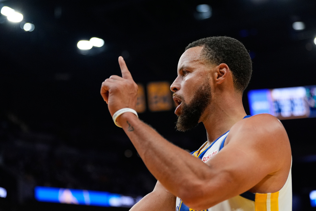 Golden State Warriors guard Stephen Curry reacts after scoring during the second half of an NBA basketball game against the Denver Nuggets, Thursday, Oct. 23, 2025, in San Francisco. (AP Photo/Godofredo A. Vásquez)