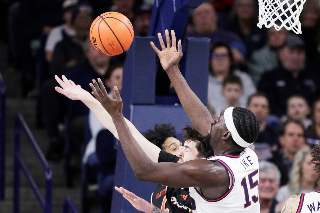 Gonzaga forward Graham Ike (15) and Pacific center Isaac Jack, left, go after a rebound during the first half of an NCAA college basketball game Saturday, Feb. 21, 2026, in Spokane, Wash. (AP Photo/Young Kwak)
