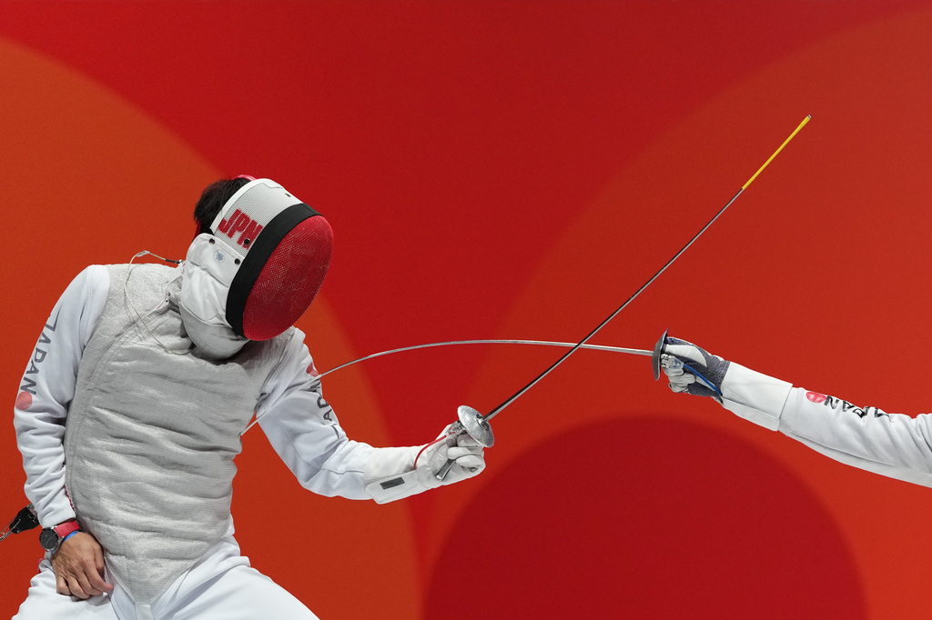 Kyosuke Matsuyama of Japan, left, competes against Kazuki Iimura of Japan during a men's foil individual fencing semi-final at the Asian Games in Nagoya, Japan, Tuesday, Sept. 22, 2026. (AP Photo/Aaron Favila)