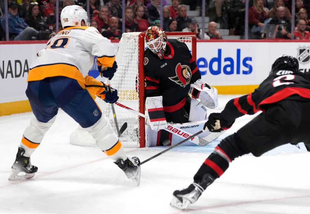 Ottawa Senators goaltender Linus Ullmark (35) makes a save on Nashville Predators' Michael Bunting (58) as Artem Zub (2) defends during first period NHL hockey action in Ottawa, Monday, Oct. 13, 2025. (Justin Tang/The Canadian Press via AP)