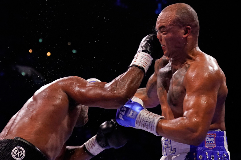 Britain's Daniel Dubois, left, lands a blow on Britain's Fabio Wardley during their WBO World Heavyweight boxing title bout in Manchester, Saturday, May 9, 2026. (AP Photo/Dave Thompson)
