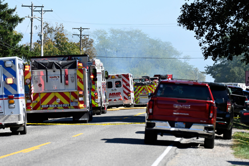 Fire and EMS vehicles are parked along McCandlish Road near a shooting that took place at The Church of Jesus Christ of Latter-day Saints, Sunday, Sept. 28, 2025, in Grand Blanc, Mich. (AP Photo/Jose Juarez)