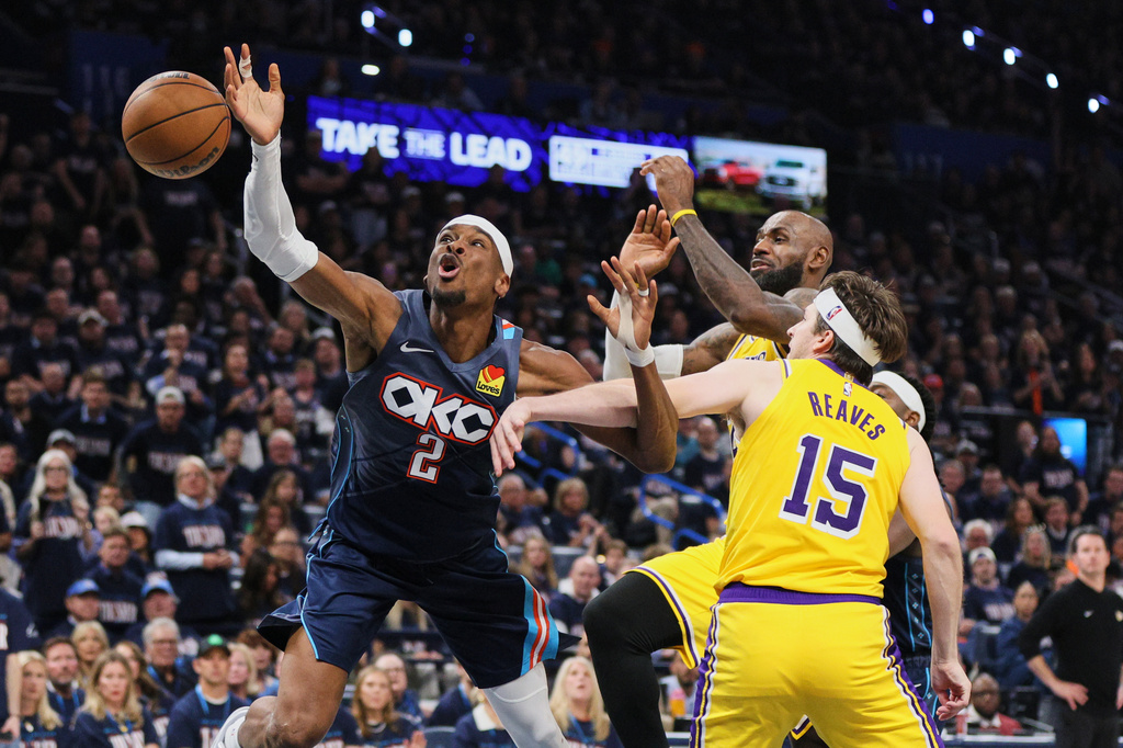 Oklahoma City Thunder's Shai Gilgeous-Alexander (2) is fouled driving to the basket by Los Angeles Lakers' Austin Reaves (15) as LeBron James, right rear, follows behind on the play in the second half of Game 2 in a second-round NBA basketball playoffs series Thursday, May 7, 2026, in Oklahoma City. (AP Photo/Nate Billings)