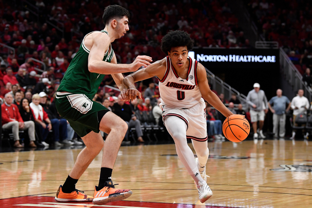 Louisville guard Mikel Brown Jr. (0) drives past Eastern Michigan forward Mohammad Habhab (4) during the second half of an NCAA college basketball game in Louisville, Ky., Monday, Nov. 24, 2025. (AP Photo/Timothy D. Easley)