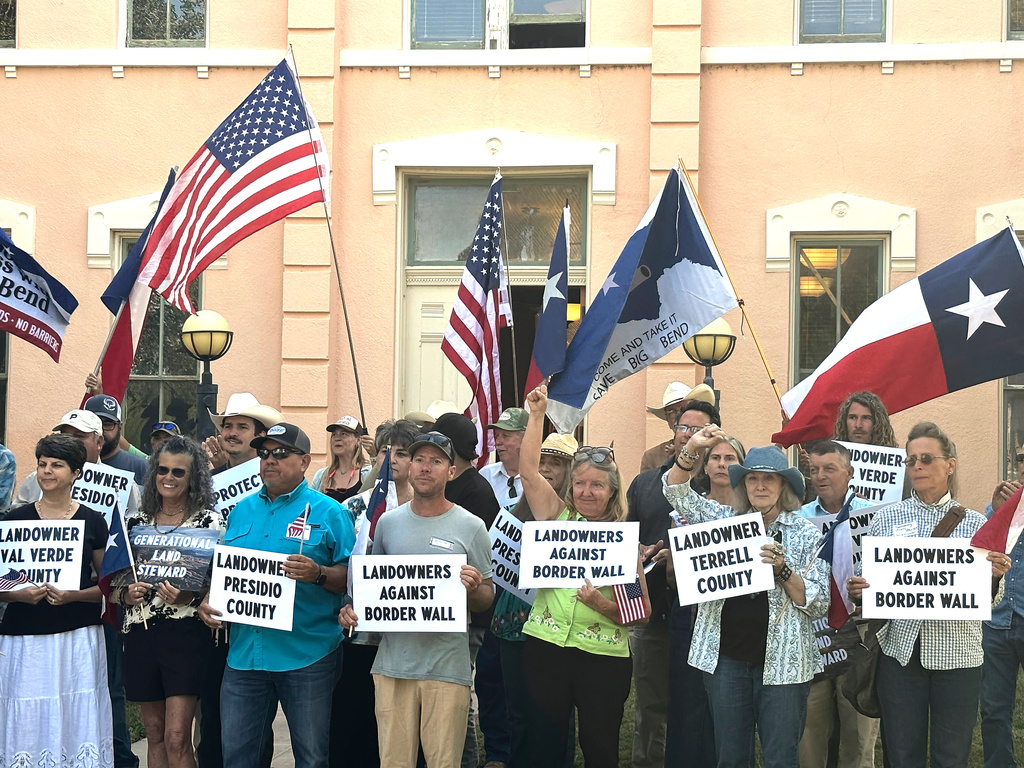 Landowners and other supporters hold signs against the Trump administration's plans to build a border wall and other infrastructure in Texas' remote Big Bend region, Monday, Sept. 14, 2026, in Marfa, Texas. (AP Photo/Rebecca Santana)