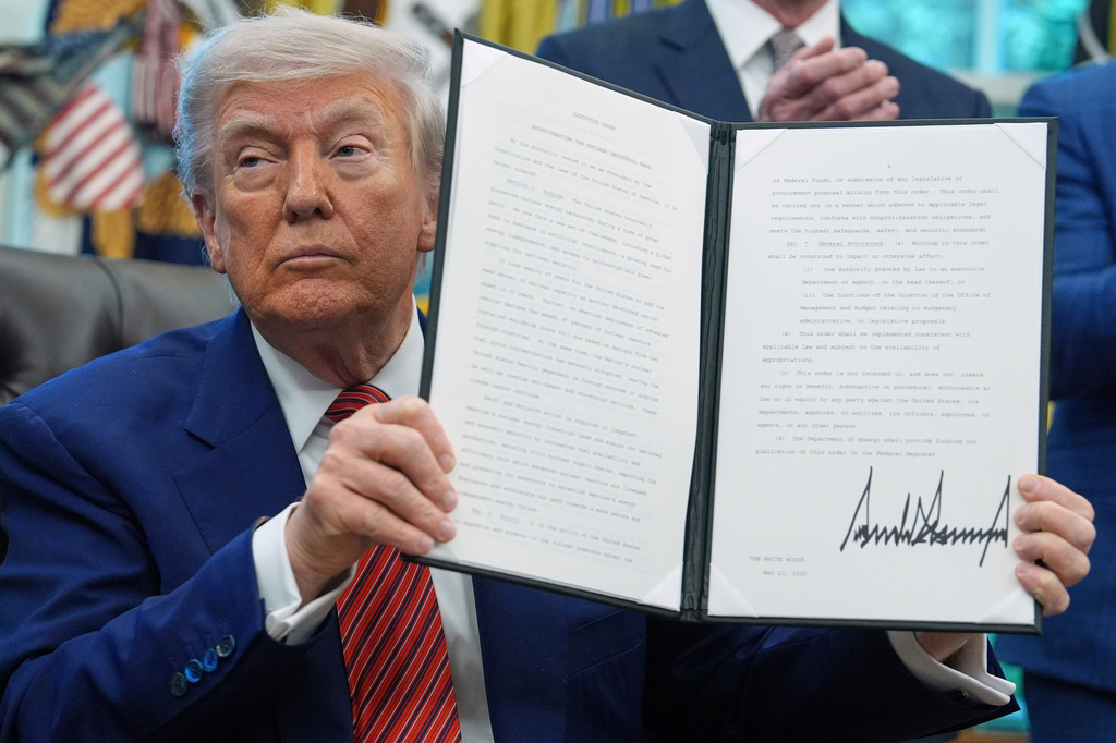 FILE - President Donald Trump holds an executive order regarding reinvigorating the nuclear industrial base in the Oval Office of the White House, May 23, 2025, in Washington. (AP Photo/Evan Vucci, File)