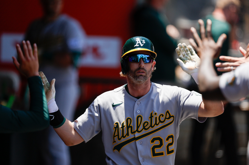 Athletics' Jeff McNeil is greeted by teammates after scoring on a sacrifice fly ball by teammate Joey Meneses during the fifth inning of a baseball game against the Los Angeles Angels, Sunday, June 28, 2026, in Anaheim, Calif. (AP Photo/Caroline Brehman)