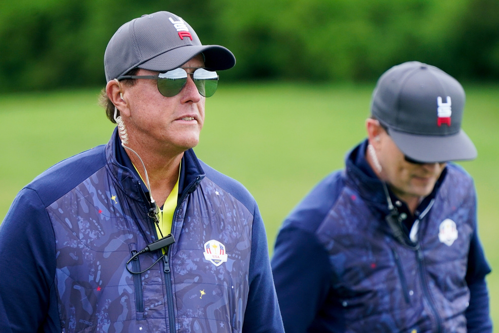 FILE - Phil Mickelson and Zack Johnson watch on the second hole during a practice day at the Ryder Cup golf matches at the Whistling Straits Golf Course, Tuesday, Sept. 21, 2021, in Sheboygan, Wis. (AP Photo/Charlie Neibergall, File)