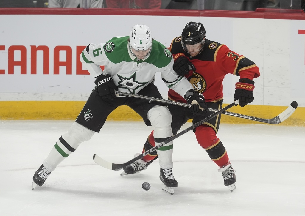 Dallas Stars defenceman Lian Bichsel (6) battle for the puck with Ottawa Senators defenceman Nick Jensen (3) during first period NHL action, in Ottawa, Tuesday, Nov. 11, 2025. (Adrian Wyld/The Canadian Press via AP)
