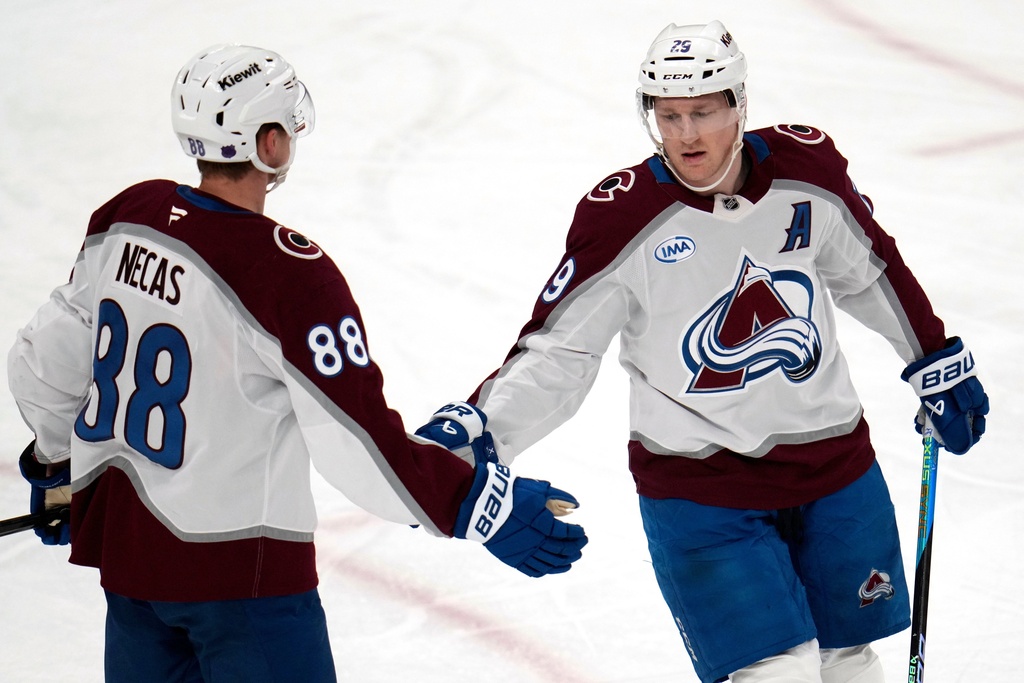 Colorado Avalanche's Nathan MacKinnon (29) celebrates with Martin Necas after scoring during the first period of an NHL hockey game against the Pittsburgh Penguins in Pittsburgh, Tuesday, March 24, 2026. (AP Photo/Gene J. Puskar)