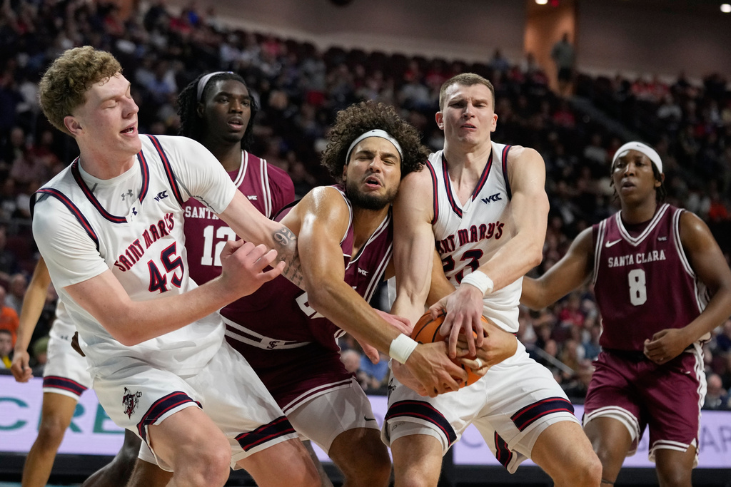 From left, Saint Mary's center Andrew McKeever (45), Santa Clara forward Allen Graves (22) and Saint Mary's forward Paulius Murauskas (23) battle for a rebound during the first half of an NCAA college basketball semifinal game in the West Coast Conference men's tournament Monday, March 9, 2026, in Las Vegas. (AP Photo/John Locher)