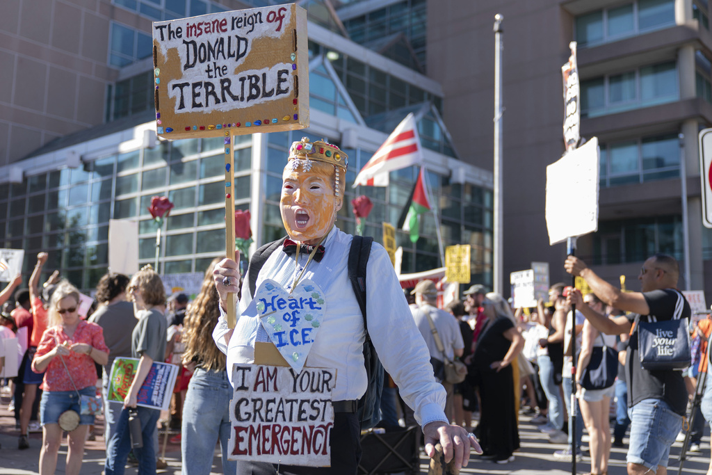 Demonstrators march as they protest against President Donald Trump's use of federal law enforcement and National Guard troops in the city during a rally along the 14th street corridor in northwest Washington, Saturday, Aug. 30, 2025. (AP Photo/Jose Luis Magana)