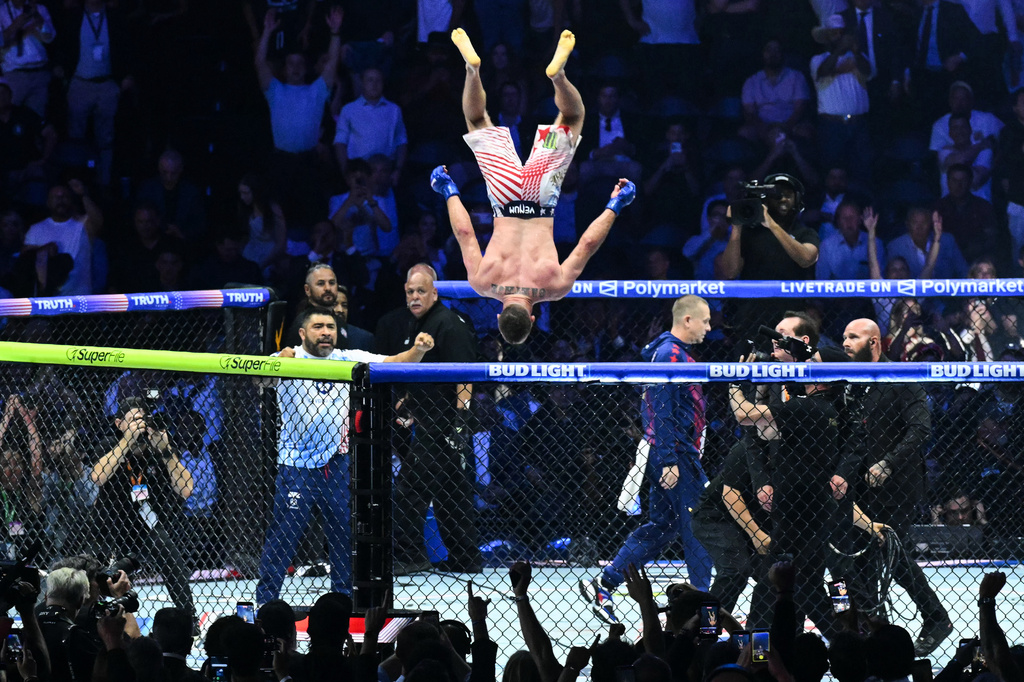 Justin Gaethje does a flip as he celebrates after defeating Ilia Topuria in a lightweight title bout during UFC Freedom 250 on the South Lawn of the White House, Monday, June 15, 2026, in Washington. (Saul Loeb/Pool Photo via AP)
