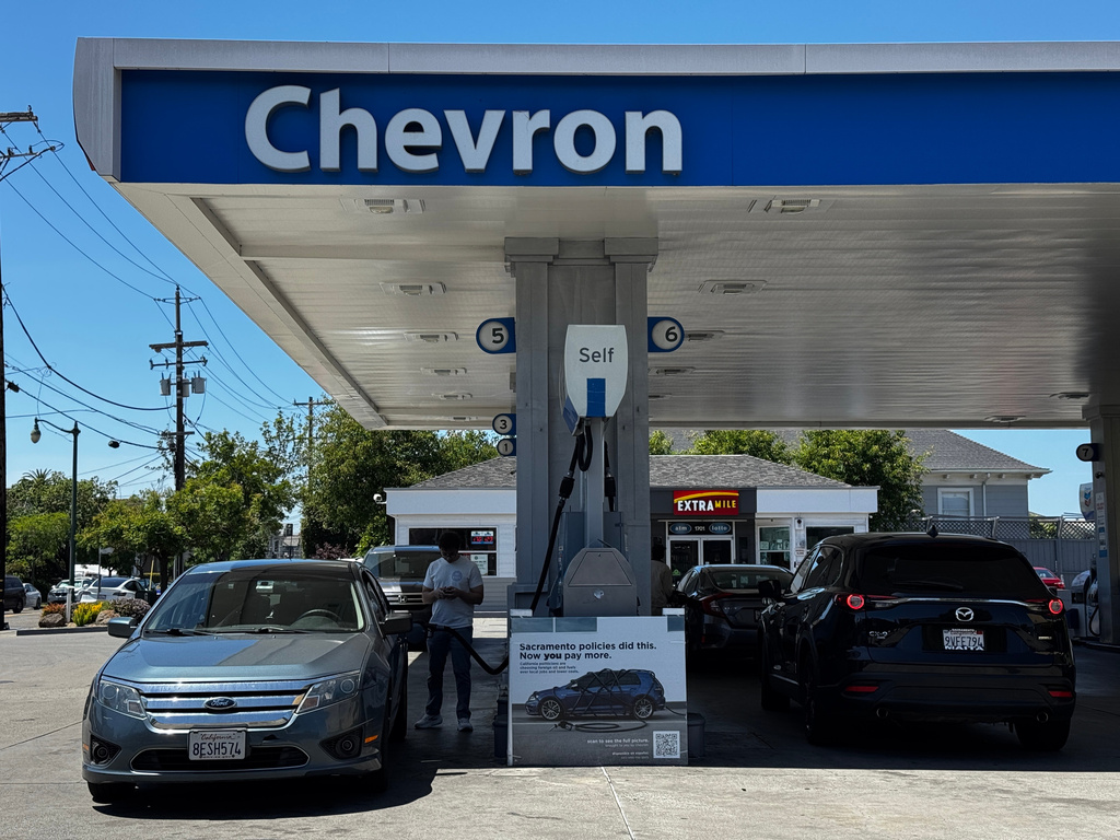 A sign blaming Sacramento policies for high gas prices is displayed at a Chevron gas station in Alameda, Calif., on Thursday, May 21, 2026. (AP Photo/Terry Chea)