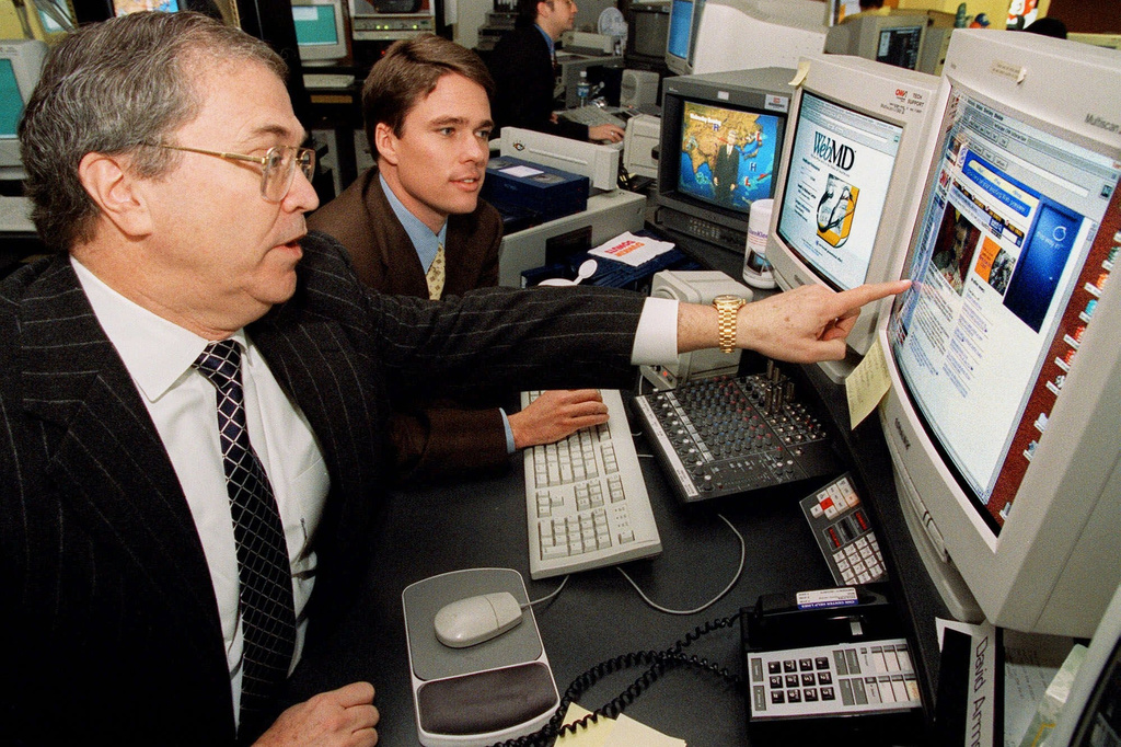 FILE - Tom Johnson, the chair,, president and CEO of CNN News Group, left, and Jeffrey Arnold, the chair, and CEO of WebMD, right, meet at the CNN Center in Atlanta, Feb. 16, 1999, following the announcement of a strategic alliance between CNN News Group and WebMD. (AP Photo/Ric Feld, File)