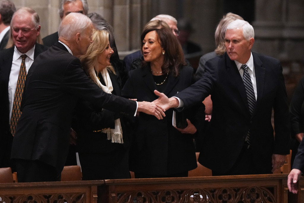 Former President Joe Biden shakes hands with former Vice President Mike Pence, with Jill Biden and former Vice President Kamala Harris, before the start of the funeral for former Vice President Dick Cheney at the Washington National Cathedral on Thursday, Nov. 20, 2025 in Washington. (AP Photo/Matt Rourke)