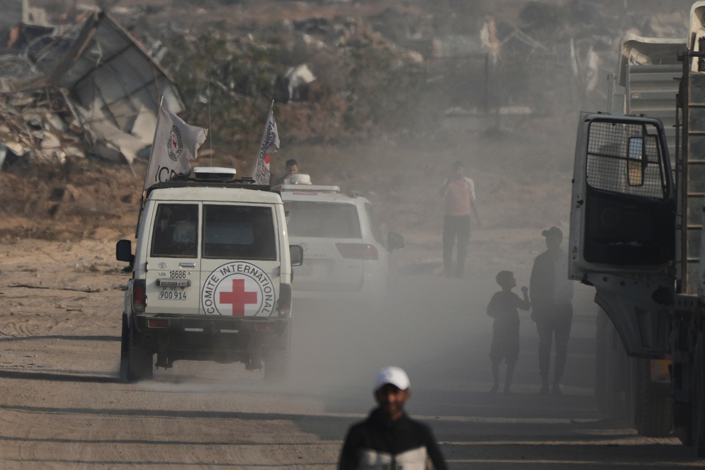 Red Cross convoy carrying what Hamas claims is the remains of an Israeli soldier who was killed in Gaza in 2014 and whose body has been held in Gaza since. makes its way toward the border crossing with Israel, to be transferred to Israeli authorities, in Deir al-Balah, Gaza Strip, Sunday, Nov. 9, 2025. (AP Photo/Jehad Alshrafi)
