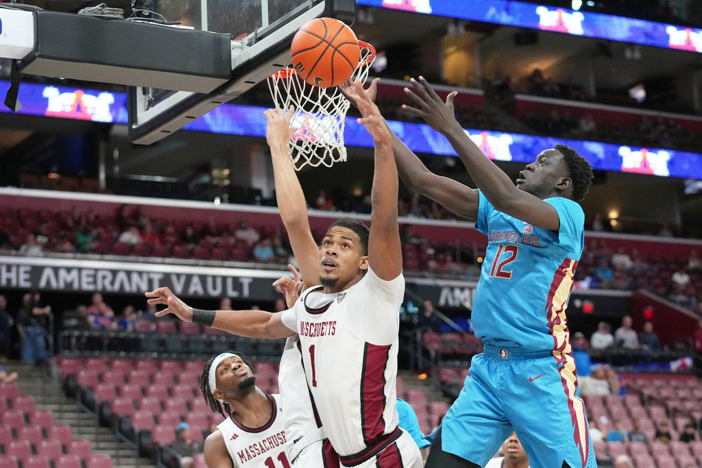 CORRECTS ID TO DANIEL HANKINS SANFORD, NOT KRIS JOHNSON - Massachusetts guard Daniel Hankins Sanford (1) and Florida State forward Alier Maluk (12) go for the ball during the first half of an NCAA college basketball game at the Orange Bowl Basketball Classic, Saturday, Dec. 13, 2025, in Sunrise, Fla. (AP Photo/Lynne Sladky)