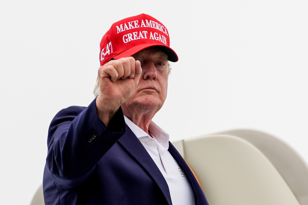 President Donald Trump gestures while boarding Air Force One at Morristown Airport, Sunday, Aug. 16, 2026, in Morristown, N.J. (AP Photo/Julia Demaree Nikhinson)