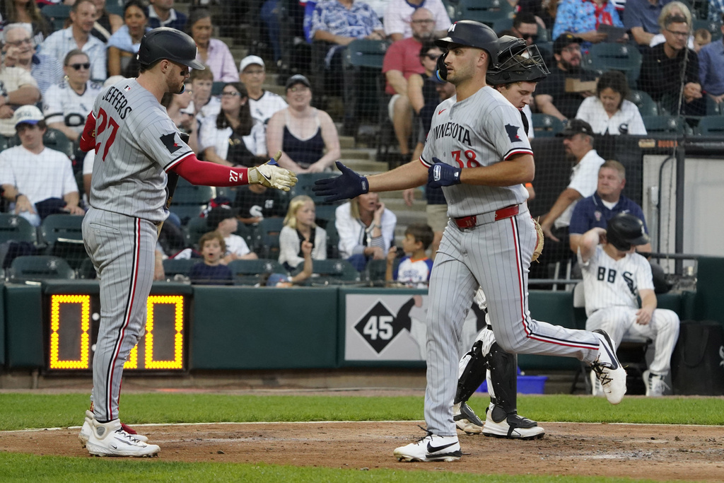 Minnesota Twins' Matt Wallner, right, is greeted by Ryan Jeffers, left, after hitting a home run against the Chicago White Sox during the fourth inning of a baseball game Saturday, August 23, 2025, in Chicago. (AP Photo/David Banks)