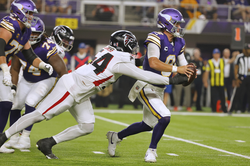 Atlanta Falcons defensive tackle Brandon Dorlus (54) sacks Minnesota Vikings quarterback J.J. McCarthy (9) during the first half of an NFL football game, Sunday, Sept. 14, 2025, in Minneapolis. (AP Photo/Bruce Kluckhohn)
