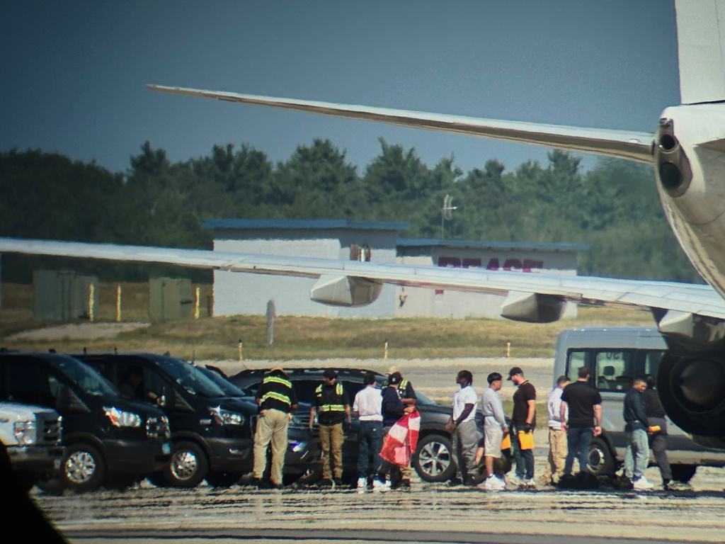 In this photo obtained by the Associated Press, ICE detainees line up to board a flight at Portsmouth International Airport at Pease, N.H., on Saturday, Aug. 16, 2025. (AP Photo)