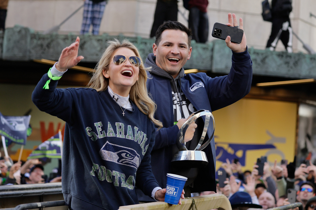 Seattle Seahawks head coach Mike MacDonald waves to the crowd during the team's NFL football Super Bowl 60 parade and celebration, Wednesday, Feb. 11, 2026, in Seattle. (AP Photo/John Froschauer)