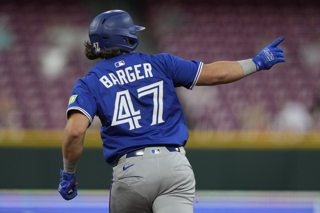 Toronto Blue Jays' Addison Barger gestures to right field as he rounds the bases after hitting a two-run homer during the fifth inning of a baseball game against the Cincinnati Reds Wednesday, Sept. 3, 2025, in Cincinnati. (AP Photo/Carolyn Kaster)