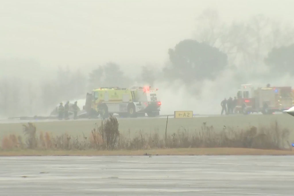 This screengrab made from video provided by WSOC shows firefighting crews responding to a reported plane crash at a regional airport in Statesville, N.C., erupting in a large fire, Thursday, Dec. 8, 2025. (WSOC via AP)