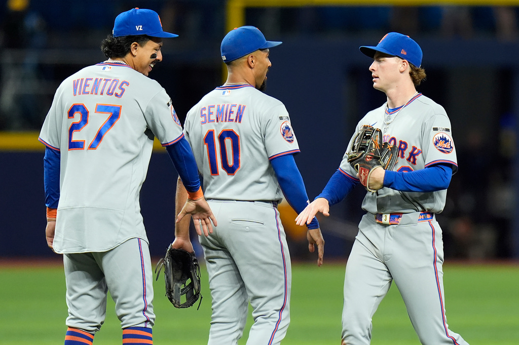 New York Mets right fielder Carson Benge celebrates with second baseman Marcus Semien (10) and Mark Vientos (27) after the team defeated the Tampa Bay Rays during a baseball game Monday, Aug. 31, 2026, in St. Petersburg, Fla. (AP Photo/Chris O'Meara)