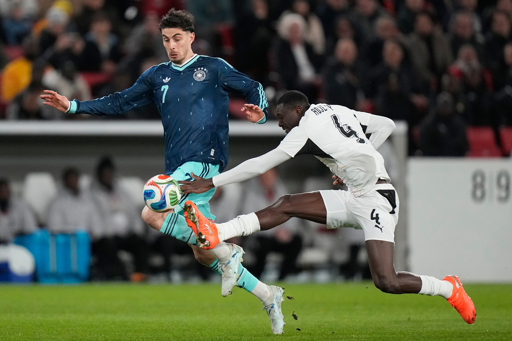 Kai Havertz of Germany is fouled by Jonas Adjetey of Ghana during an international friendly soccer match between Germany and Ghana in Stuttgart, Germany, Monday, March 30, 2026. (AP Photo/Matthias Schrader)