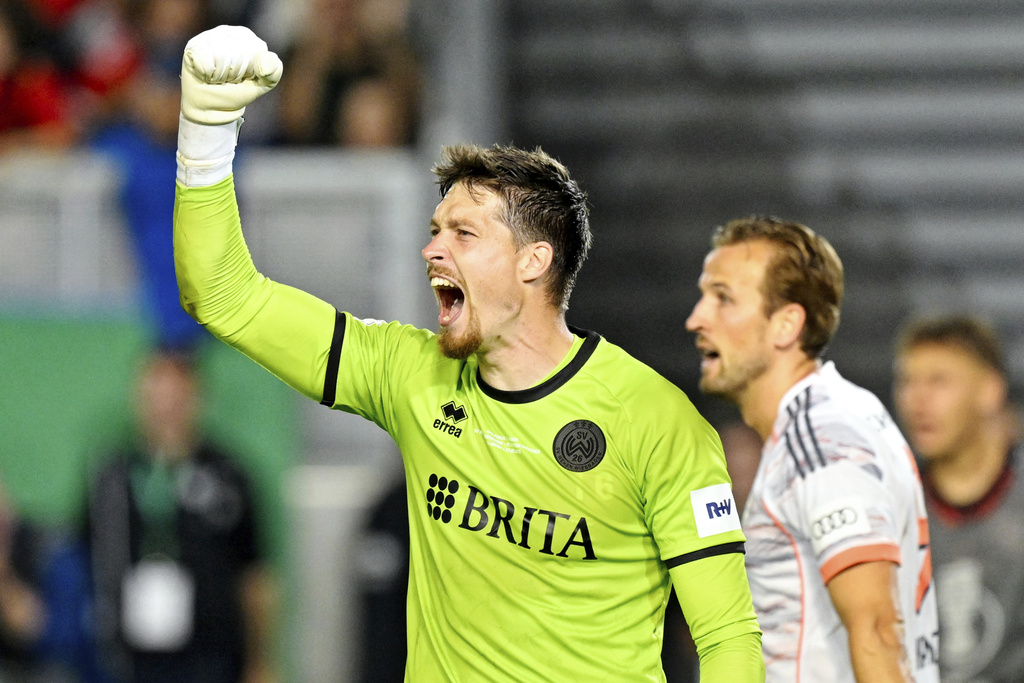 SV Wehen Wiesbaden goalkeeper Florian Stritzel celebrates after saving a penalty kick by Bayern Munich's Harry Kane during the DFB Pokal, Germany Cup, soccer match, Wednesday, Aug 27, 2025, in Wiesbaden, Germany. (Uwe Anspach/dpa via AP)