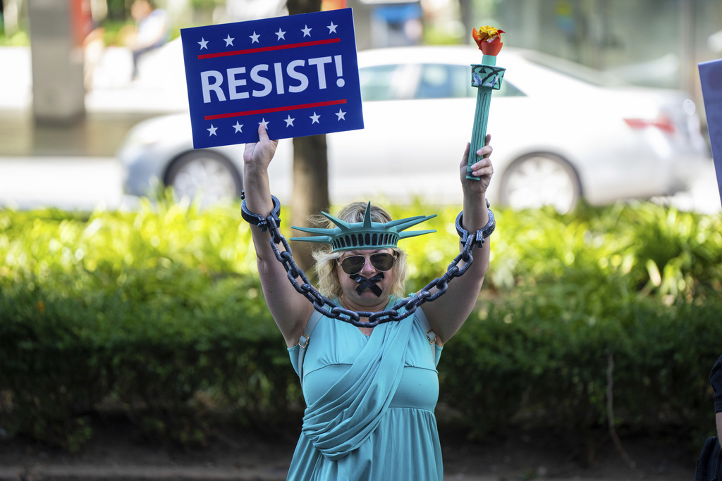 A woman dressed as the Statue of Liberty in chains protests at the "Make Billionaires Pay" climate march in New York, Saturday, Sept. 20, 2025. (AP Photo/Angelina Katsanis)