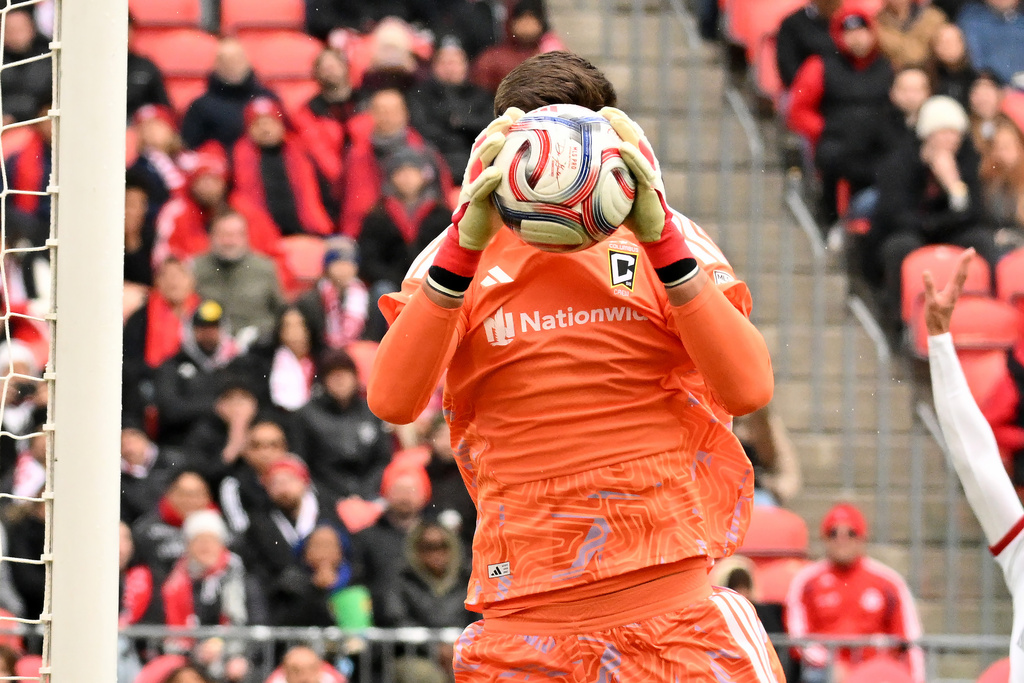 Columbus Crew goalkeeper Patrick Schulte (28) makes a save against Toronto FC during the first half of an MLS soccer game in Toronto, Saturday, March 21, 2026. (Jon Blacker/The Canadian Press via AP)