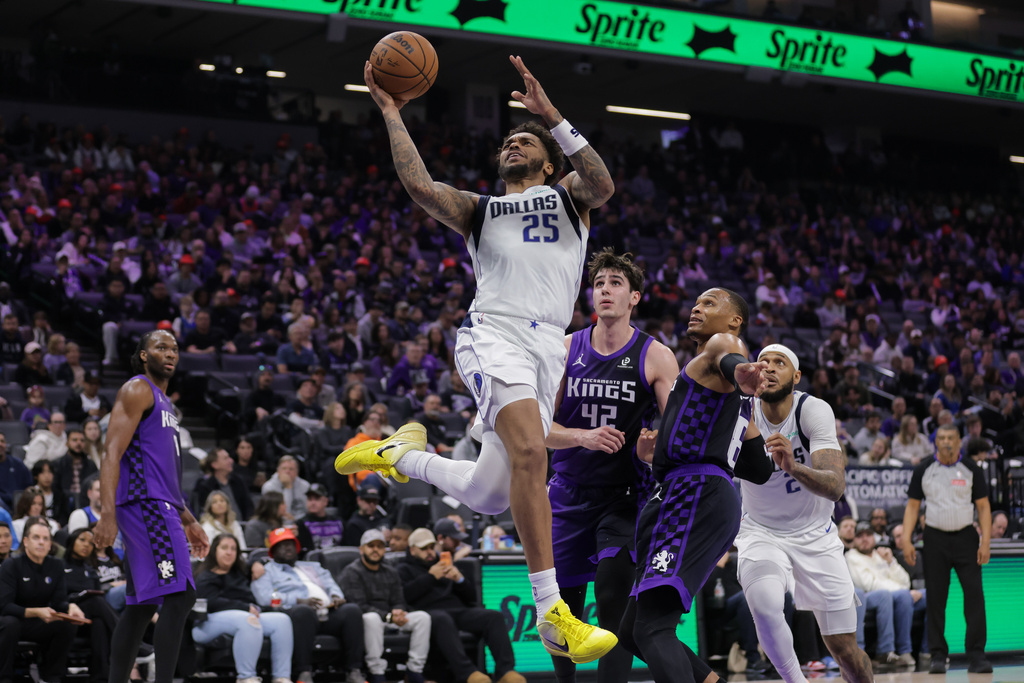 Dallas Mavericks forward P.J. Washington Jr. (25) attempts a layup as he's fouled during the first half of an NBA basketball game against the Sacramento Kings, Saturday, Dec. 27, 2025, in Sacramento, Calif. (AP Photo/Scott Marshall)