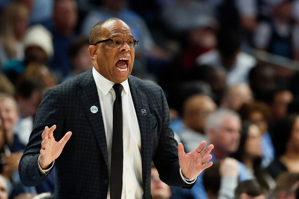 North Carolina head coach Hubert Davis directs his team during the first half of an NCAA college basketball game against Clemson in the quarterfinals of the Atlantic Coast Conference tournament in Charlotte, N.C., Thursday, March 12, 2026. (AP Photo/Nell Redmond)
