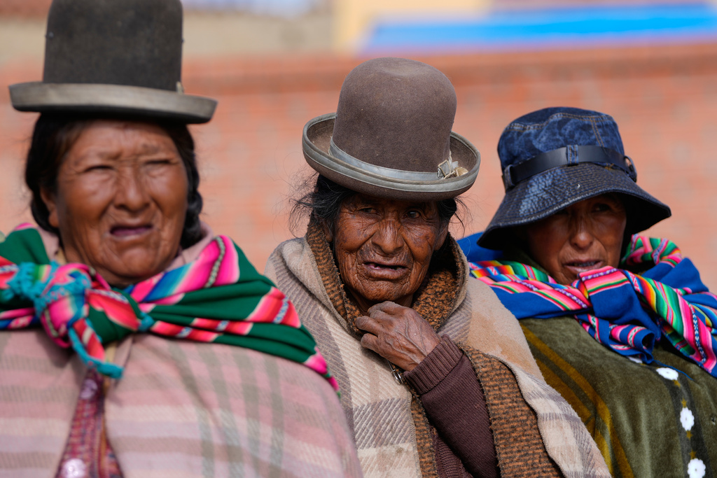 Voters line up at a polling station during a presidential runoff election in Achacachi, Bolivia, Sunday, Oct. 19, 2025. (AP Photo/Juan Karita)